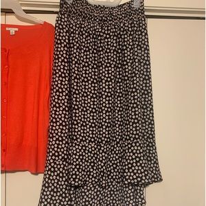 Black skirt with orange flowers.